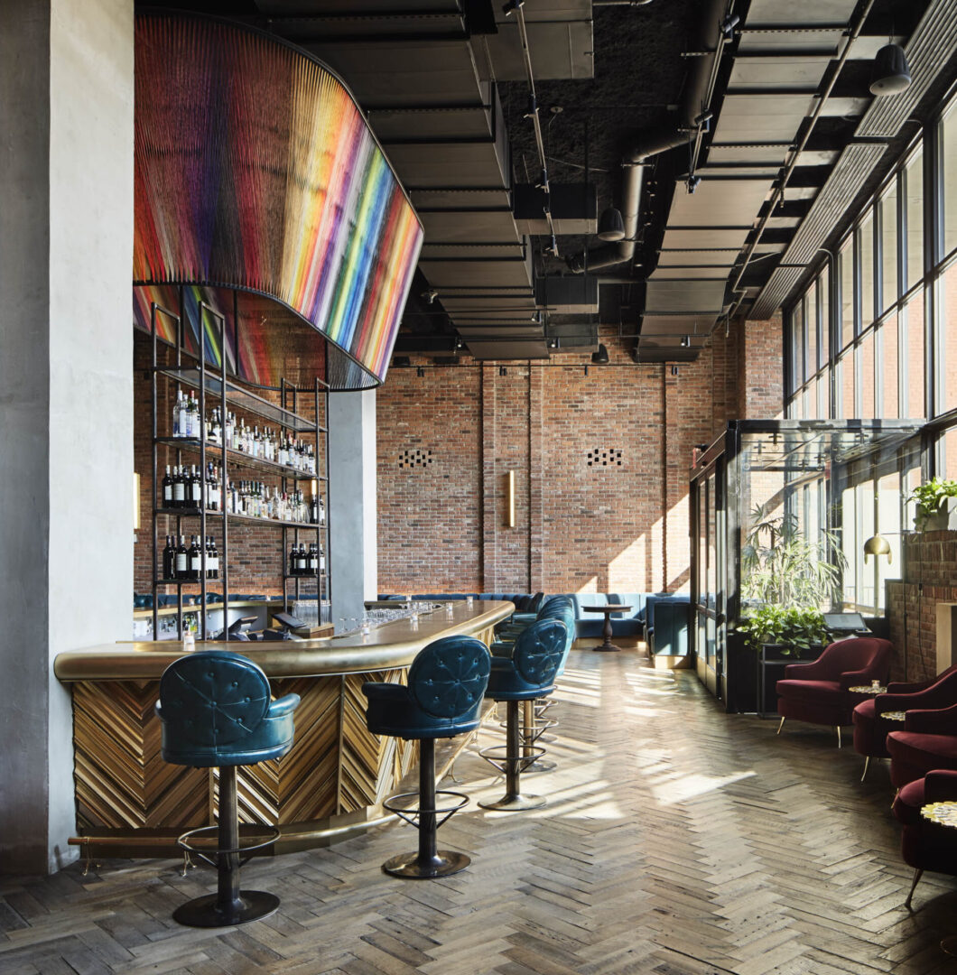 Modern bar with brick walls and plush seating.