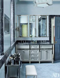 A modern bathroom with a large mirror.